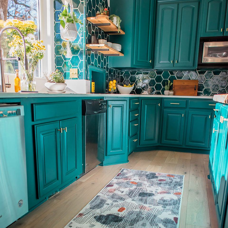 abstract runner rug in kitchen with teal cabinets