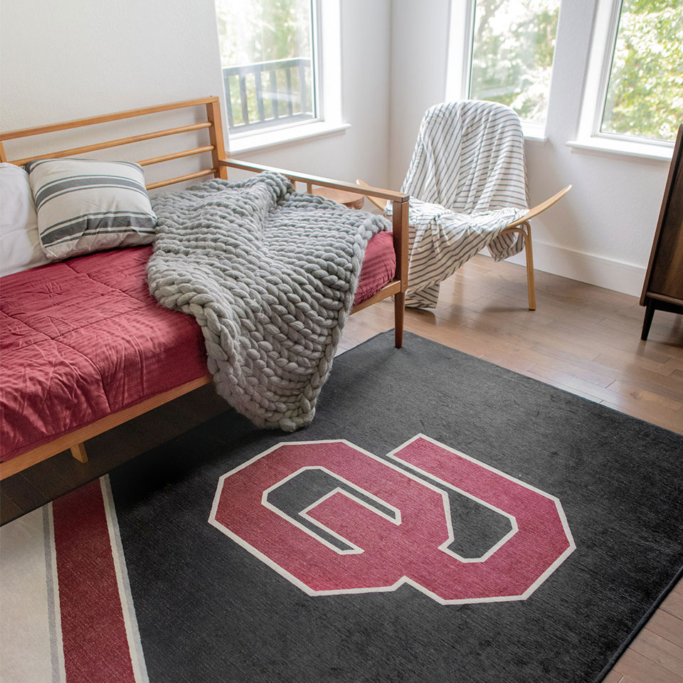 college logo rug in dorm room