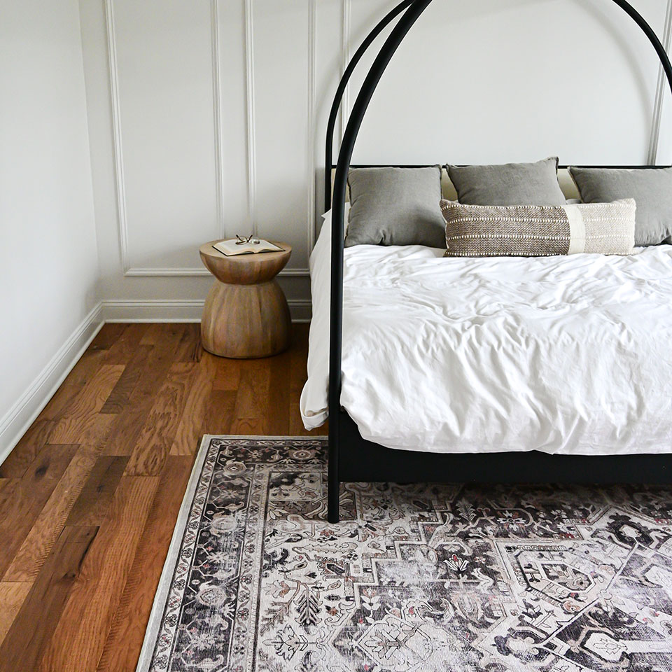 dark persian rug in scandi bedroom