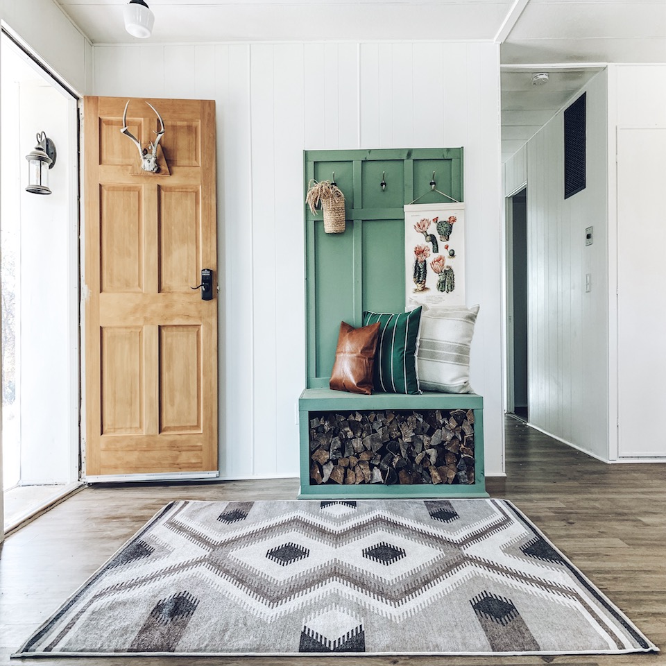 rustic decor in entryway with geometric rug