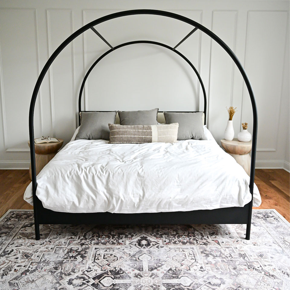 minimalist bedroom with distressed rug