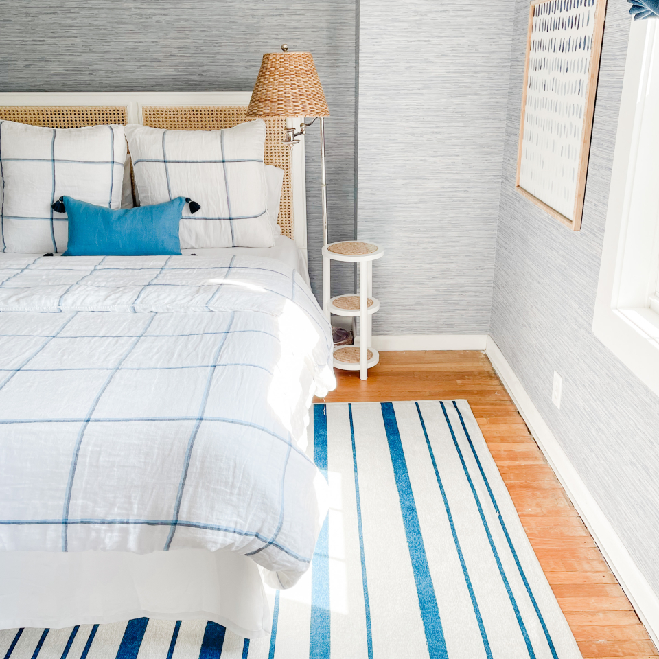 blue stripe rug in bedroom with coastal decor
