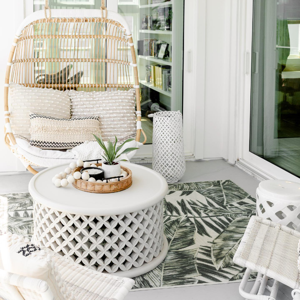 coastal inspired patio with palm green rug
