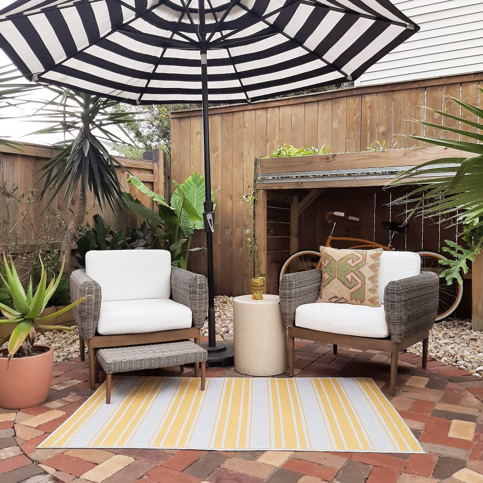 striped rug on nature inspired patio