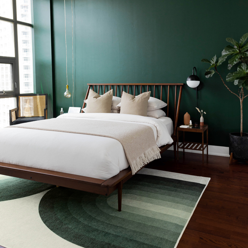 green abstract rug in mid-century modern bedroom